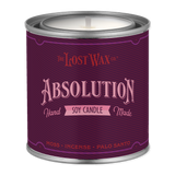 Purple candle container labeled 'Absolution' by The Lost Wax Co. on a white background