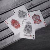 Four aces on a wooden background.