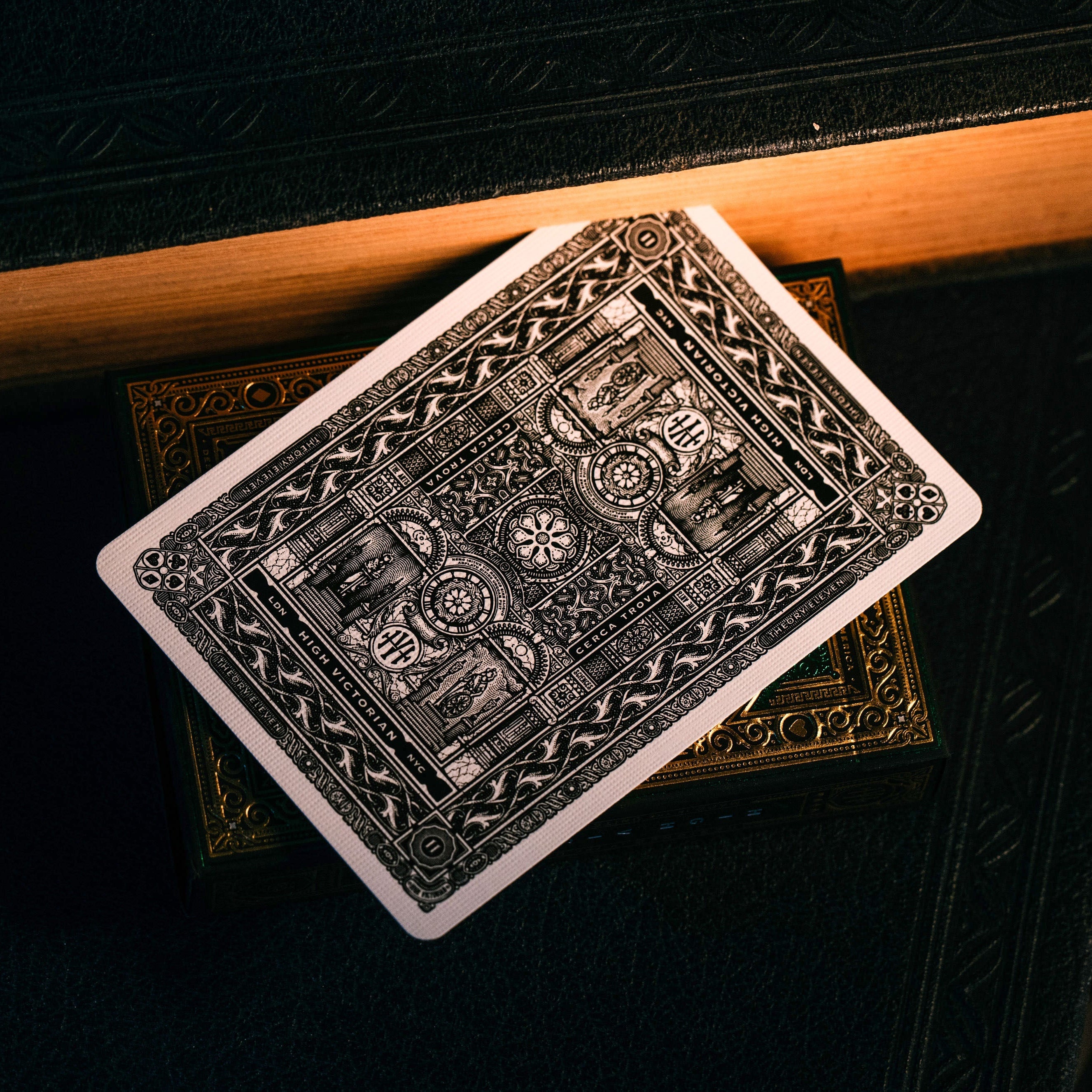 Playing card with intricate design on a dark surface