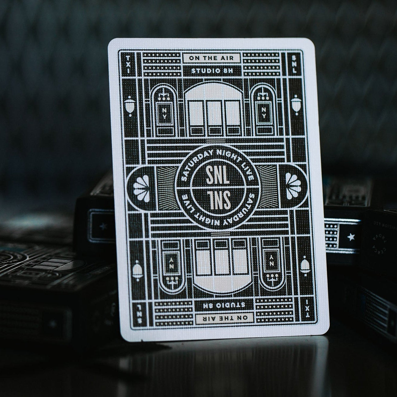 Reverse side of the SNL playing cards, with a geometric illustration of Studio 8H.