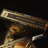Black and gold playing cards with 'Made in the United States' text on a dark background