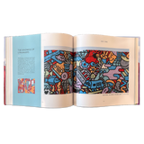 Double-page spread with a large photograph of a colorful mural of abstract shapes depicting a cardinal, donut, commuter train, pizza, fish and other icons.