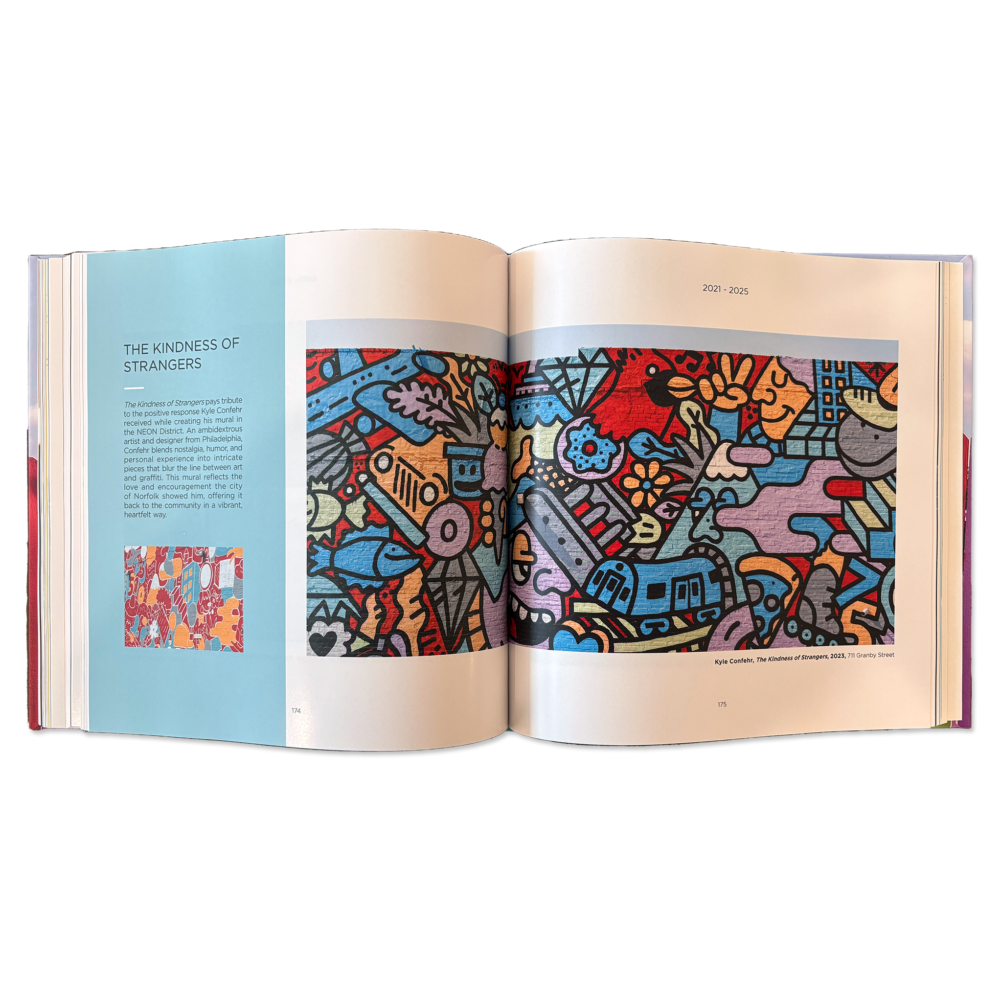Double-page spread with a large photograph of a colorful mural of abstract shapes depicting a cardinal, donut, commuter train, pizza, fish and other icons.