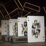Spades court cards arranged on a wooden surface with a dark background