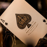 Close-up of a playing card with intricate design and text, blurred background