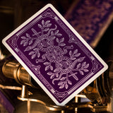 Purple playing card with white design on a mechanical background