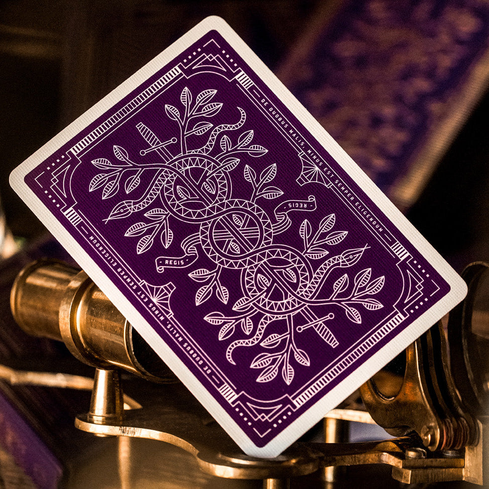 Purple playing card with white design on a mechanical background