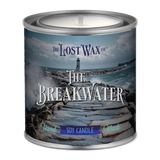 Candle in a tin labeled 'The Breakwater' from The Lost Wax Co. with a scenic design on the label.