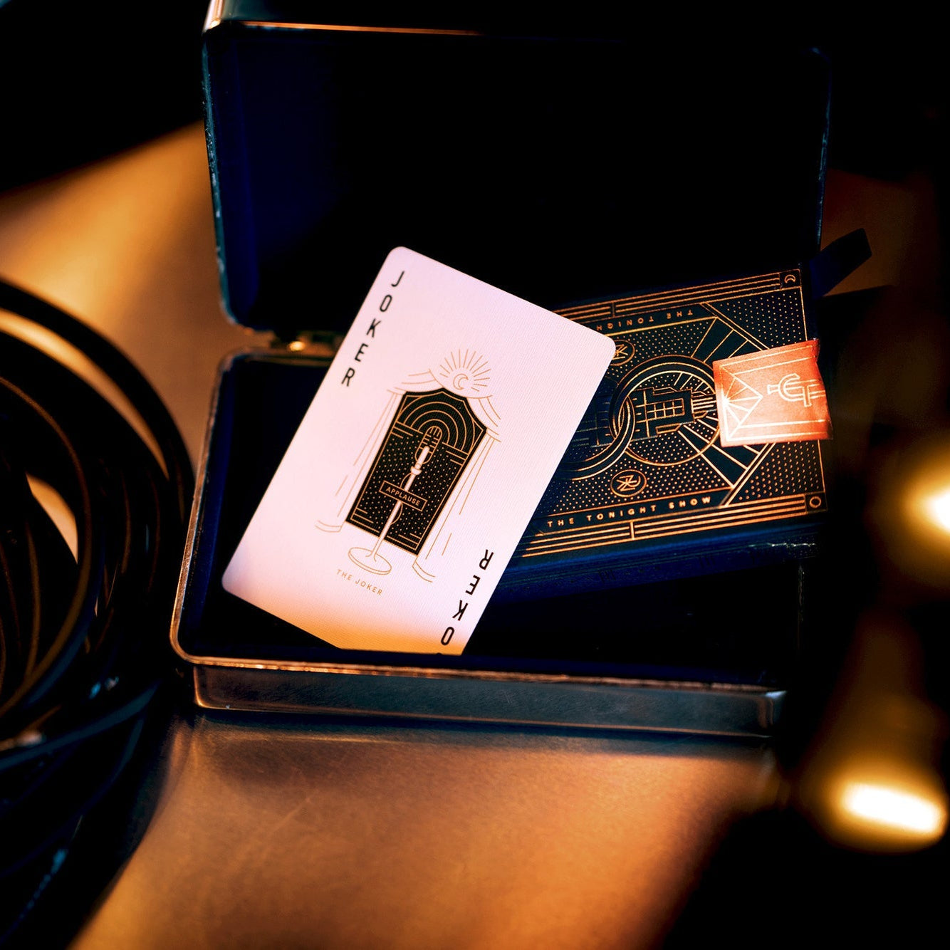 Card in a display case on a reflective surface with blurred lights in the background