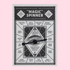 Card printed with a black and white design and a spinning arrow mounted in the center.