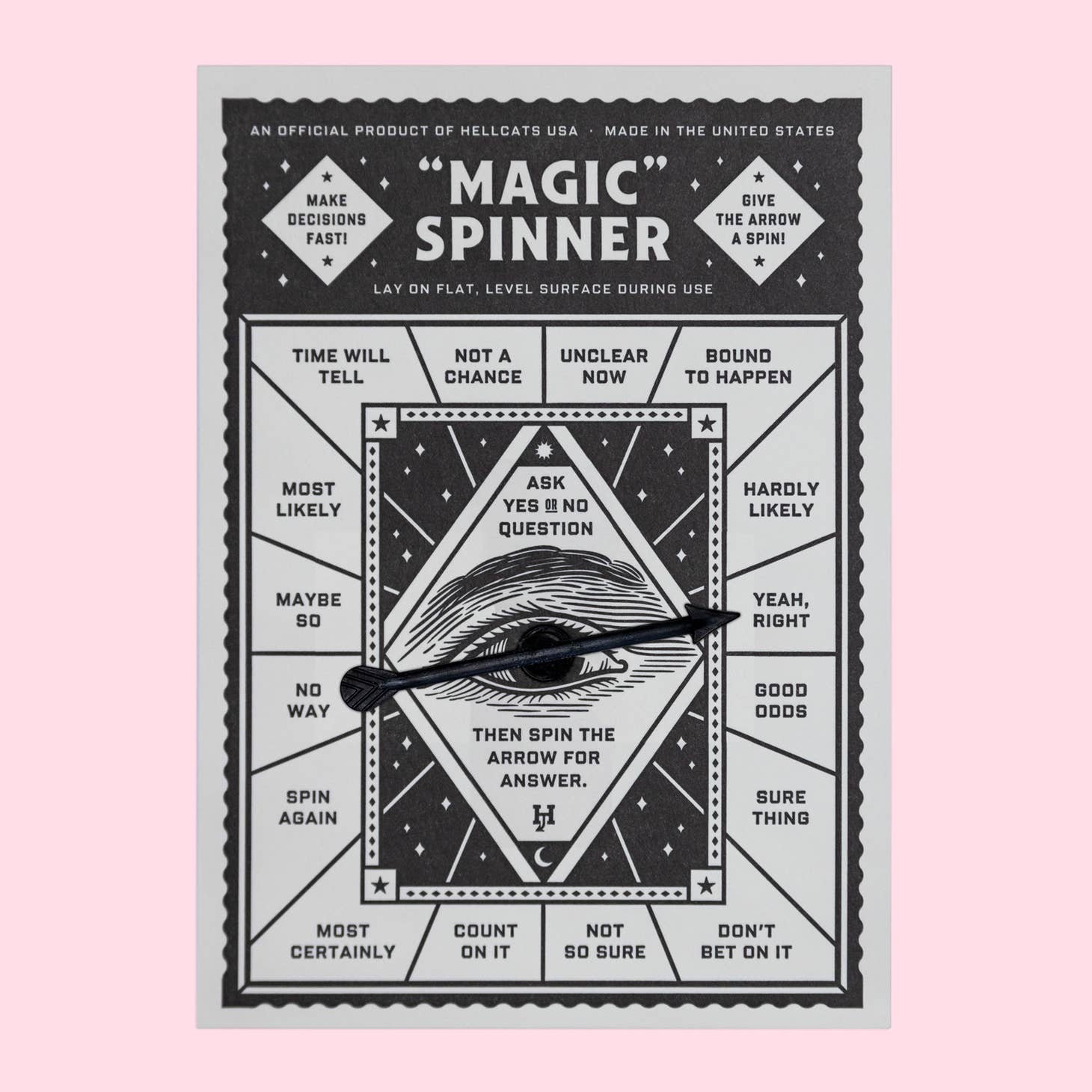 Card printed with a black and white design and a spinning arrow mounted in the center.
