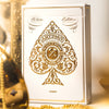 White edition playing cards with gold design on a blurred background