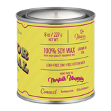 Yellow candle canister with text on a white background