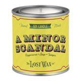 Candle canister labeled 'A Minor Scandal' by The Lost Wax Co. on a white background