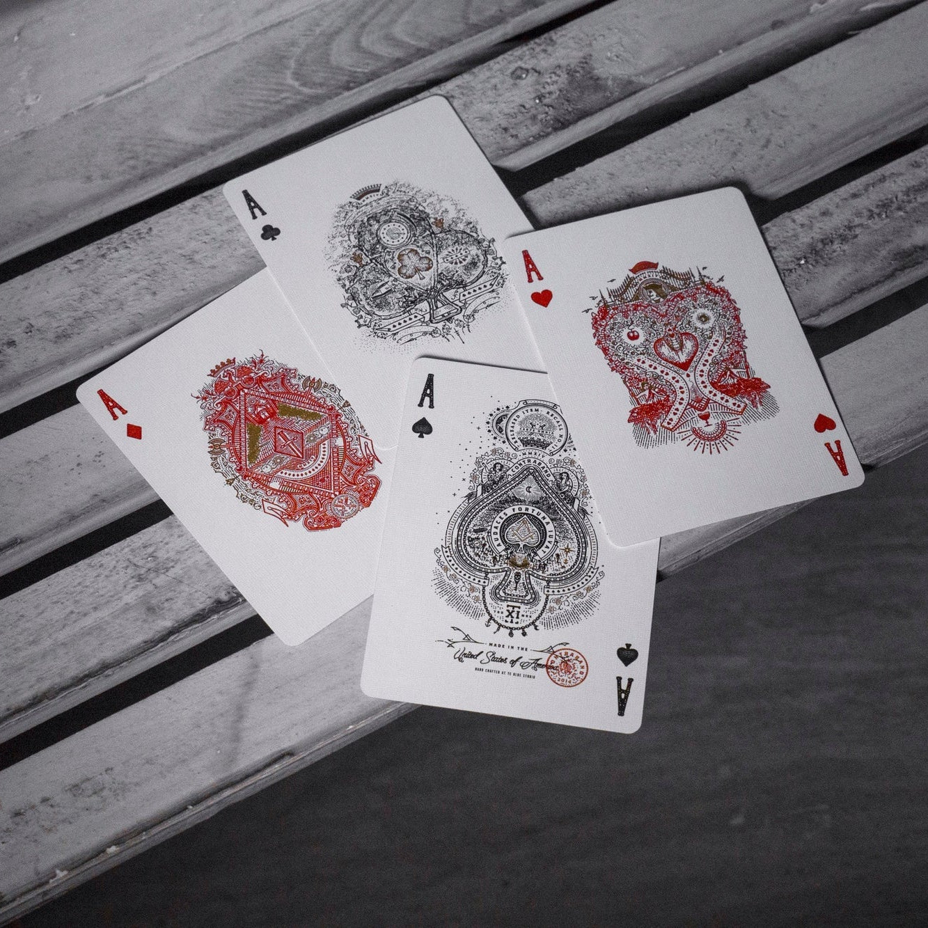 Four aces on a wooden background.