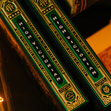 Two green and gold boxes with text on a dark background