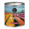 Candle in a can labeled 'Dutch Spring' with a scenic design on the label.