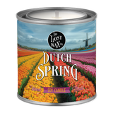 Candle in a can labeled 'Dutch Spring' with a scenic design on the label.