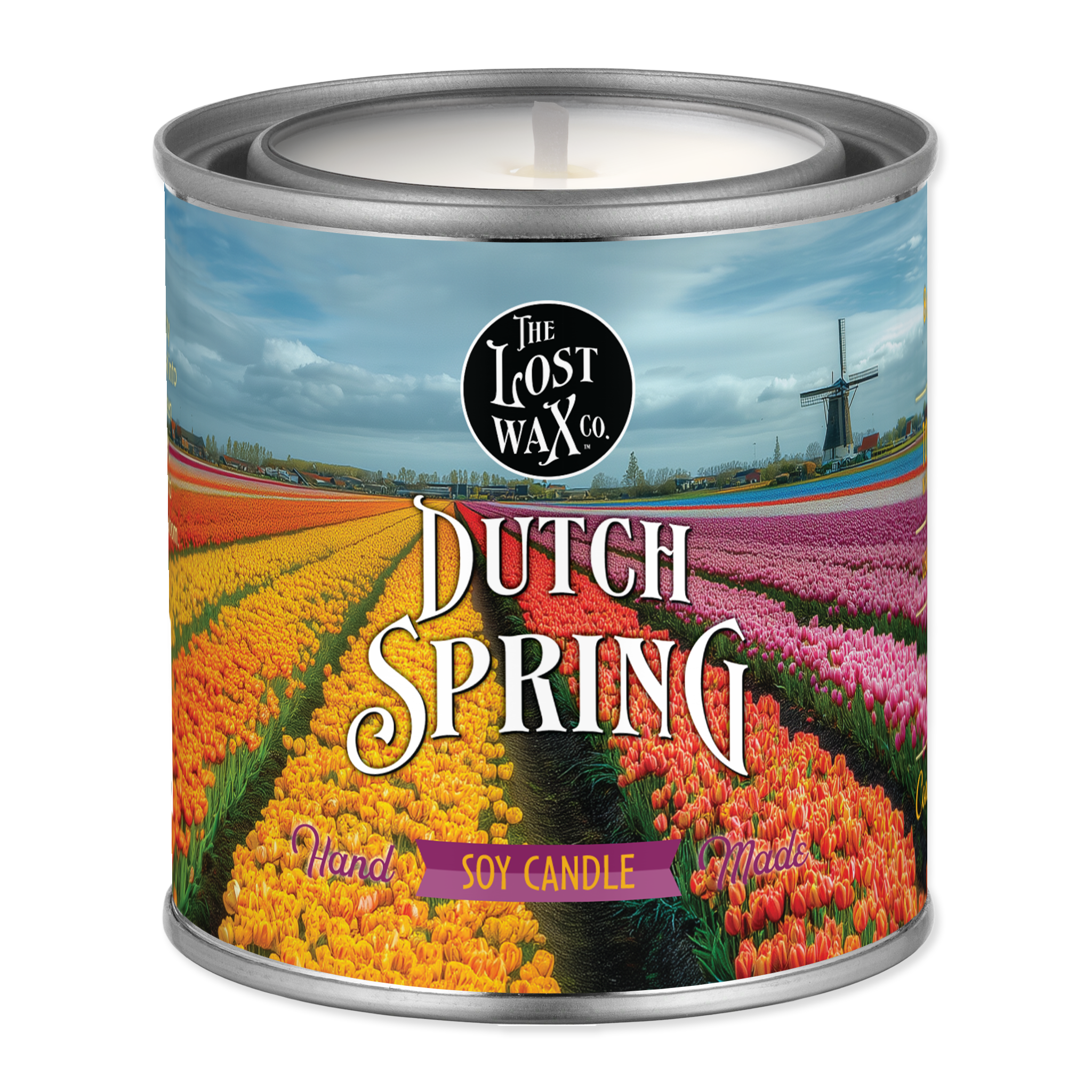 Candle in a can labeled 'Dutch Spring' with a scenic design on the label.