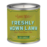 Candle canister labeled 'Freshly Mown Lawn' by Frost Wax on a white background
