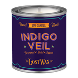 Candle in a purple canister with 'Indigo Veil' branding on a white background