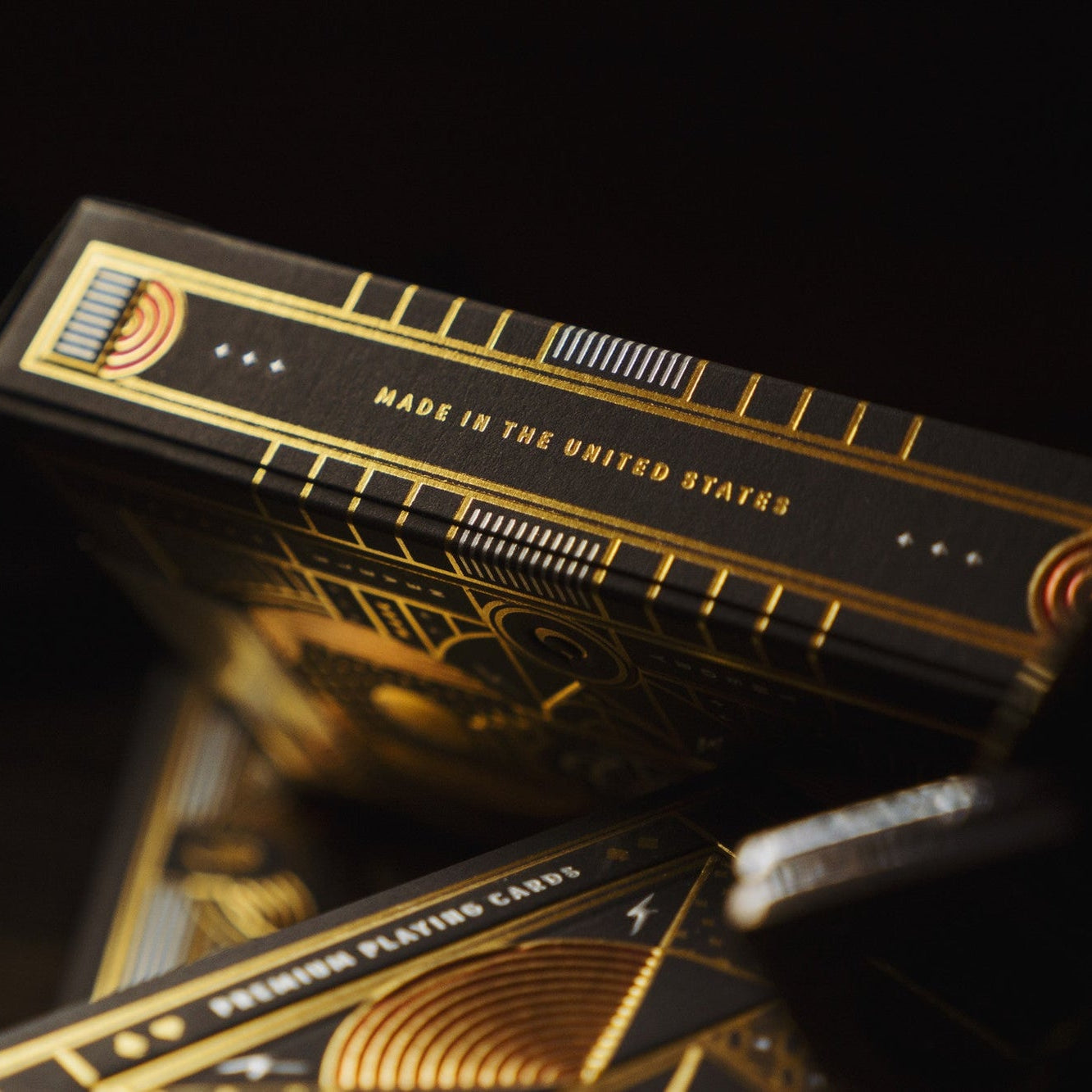 Black and gold playing cards with 'Made in the United States' text on a dark background