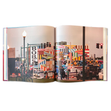 double-page spread of a photograph of an urban scene including buildings with colorful murals painted on them.