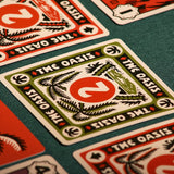 Desperate Oasis game cards on a green fabric background