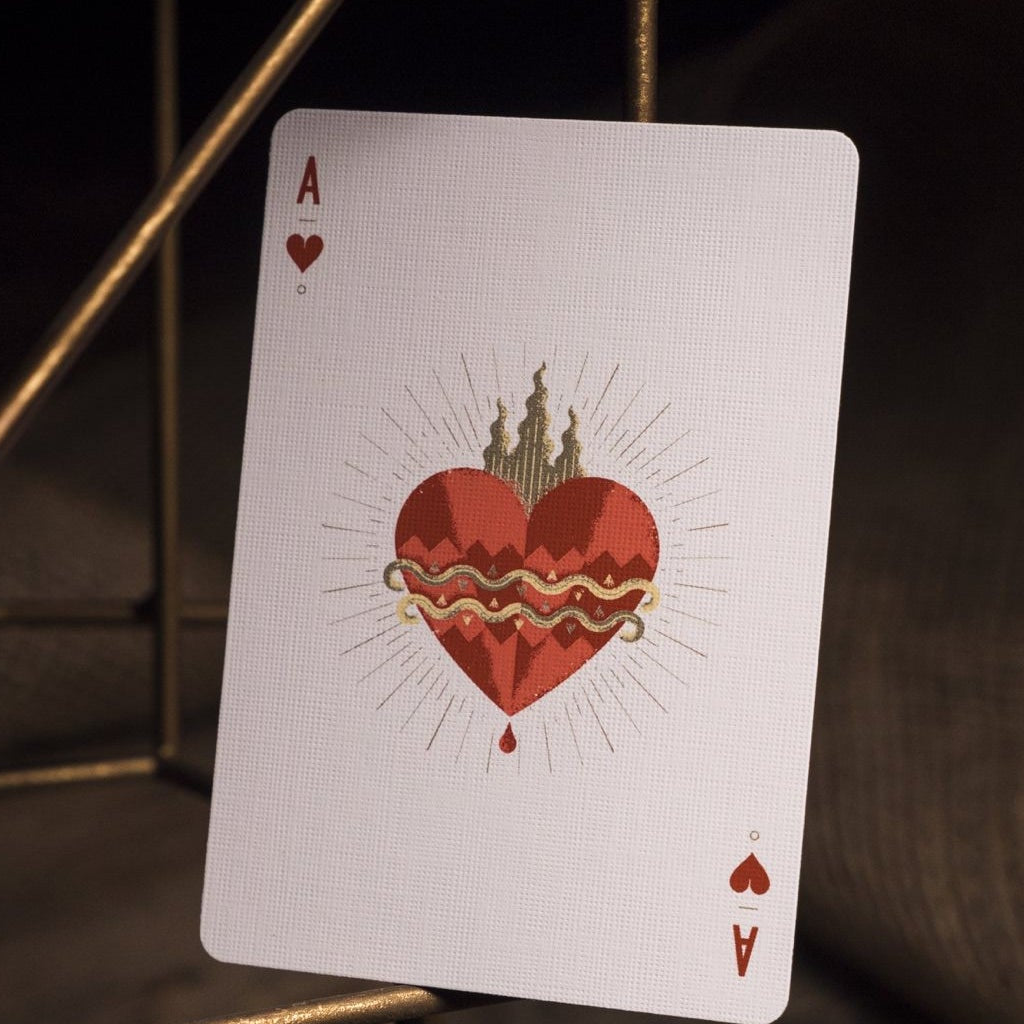 Playing card with a red heart design on a dark background