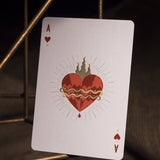 Playing card with a red heart design on a dark background