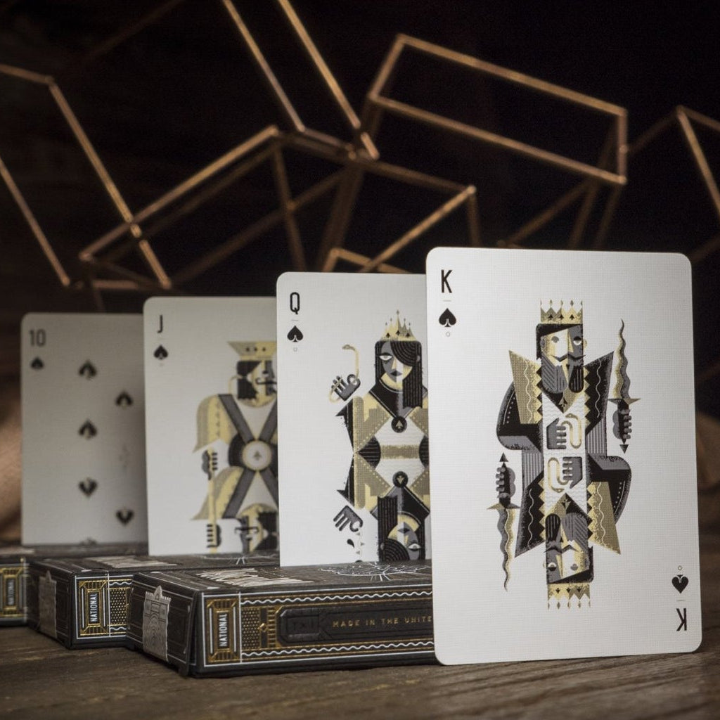 Spades court cards arranged on a wooden surface with a dark background