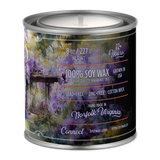 Candle in a tin with a scenic label on a white background