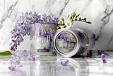 Two 'Petal's on the Path' candles with flowers on a marble surface