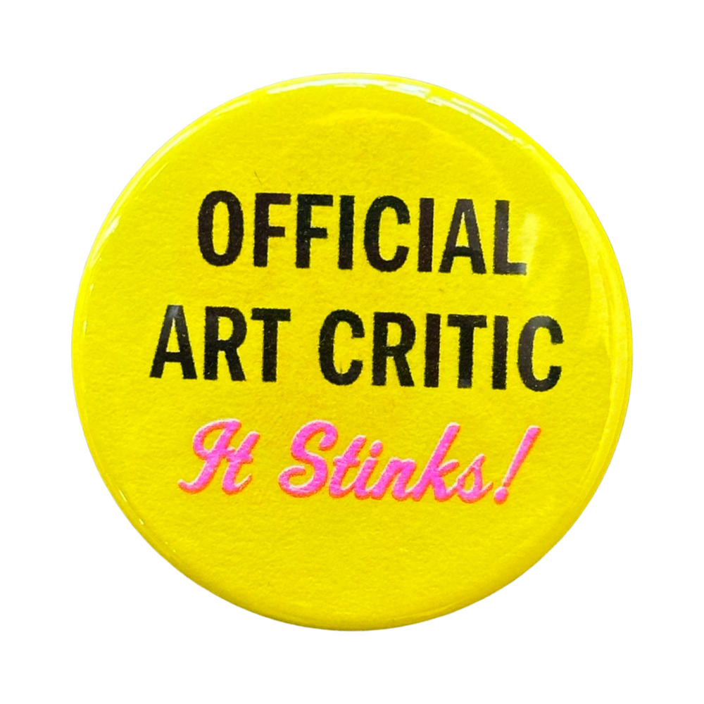 Yellow button with a slogan: Official Art Critic - It Stinks!