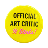 Yellow button with a slogan: Official Art Critic - It Stinks!