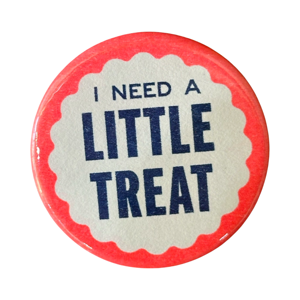 Blue lettering on a pink and white button