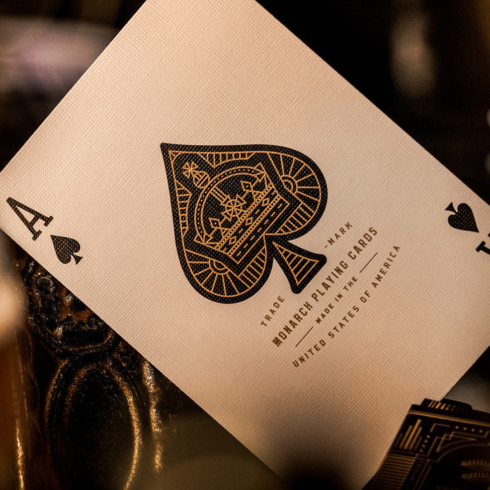 Close-up of a playing card with intricate design and text, blurred background
