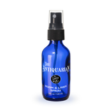 Blue spray bottle with a label on a white background