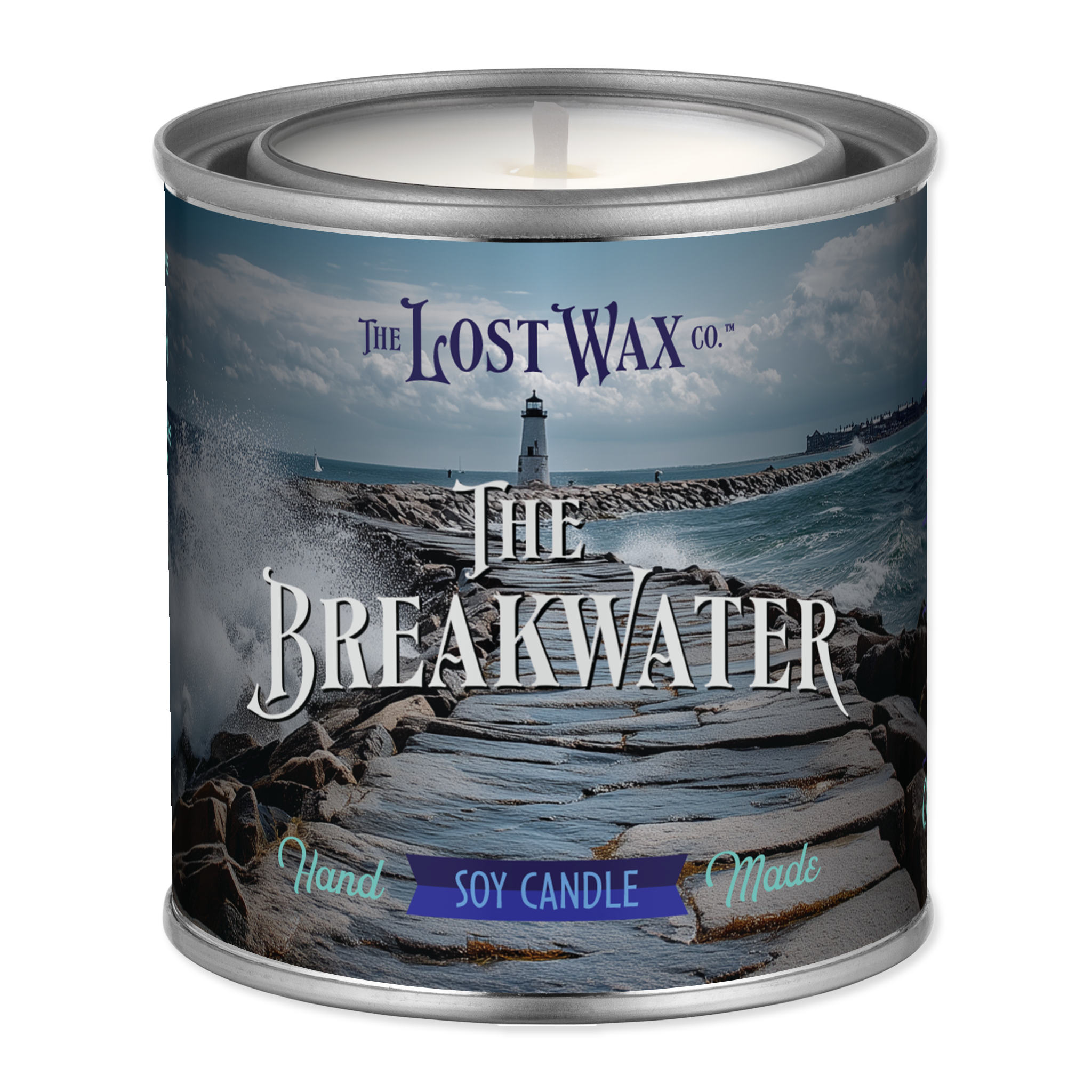 Candle in a tin labeled 'The Breakwater' from The Lost Wax Co. with a scenic design on the label.
