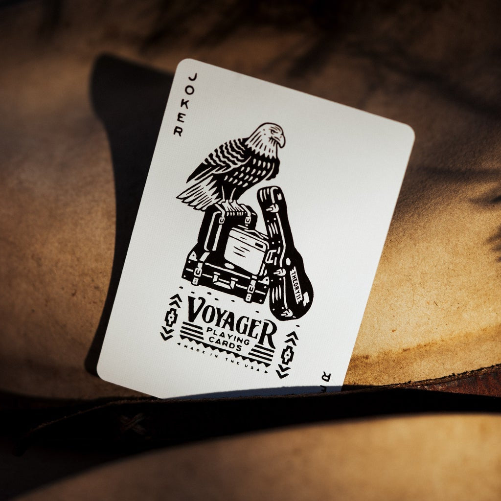 Voyager playing cards Joker, featuring a Bald Eagle with suitcases and a guitar