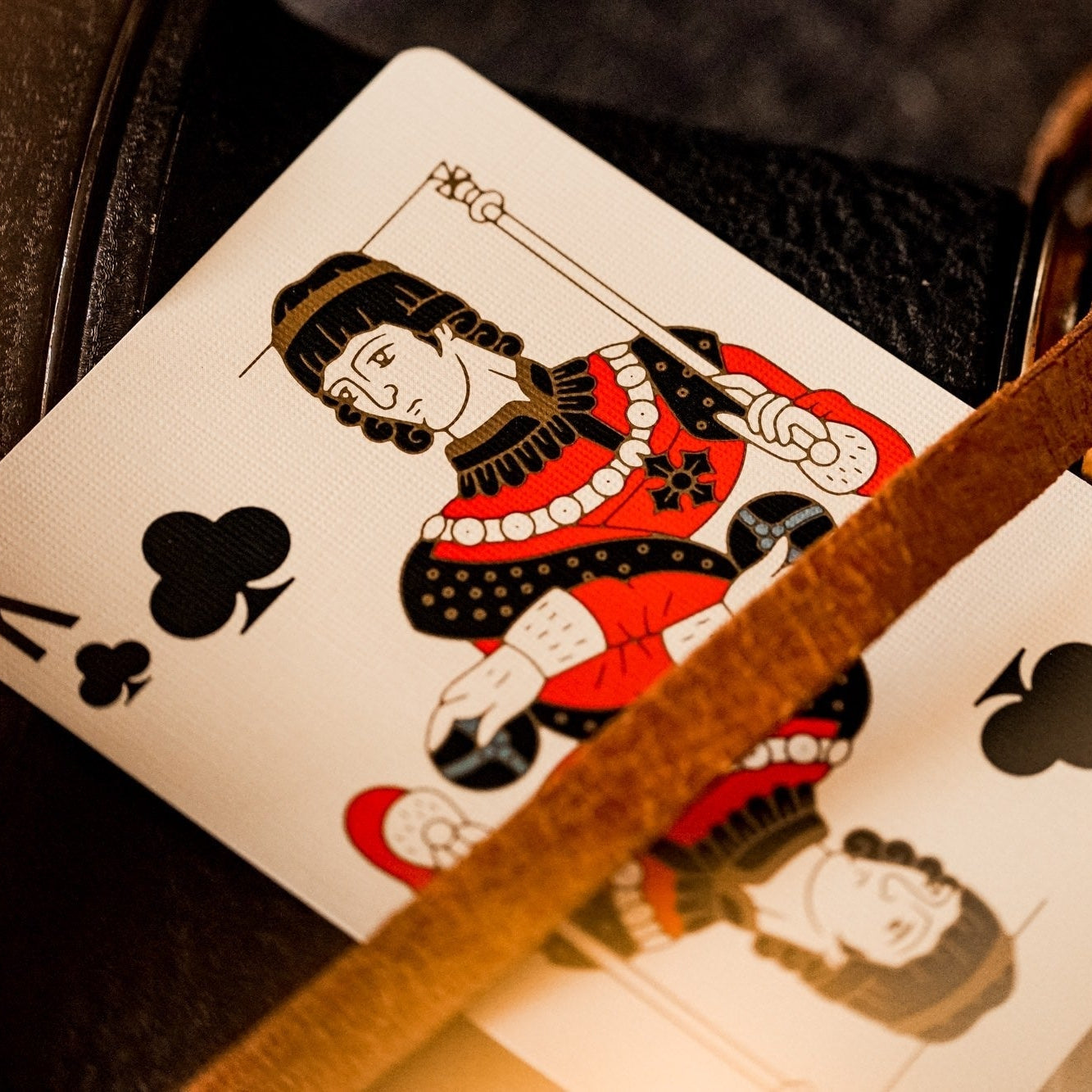Playing card with a King design on a leather surface