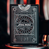 A pack of Star Wars playing cards with a black box with silver foil detail.