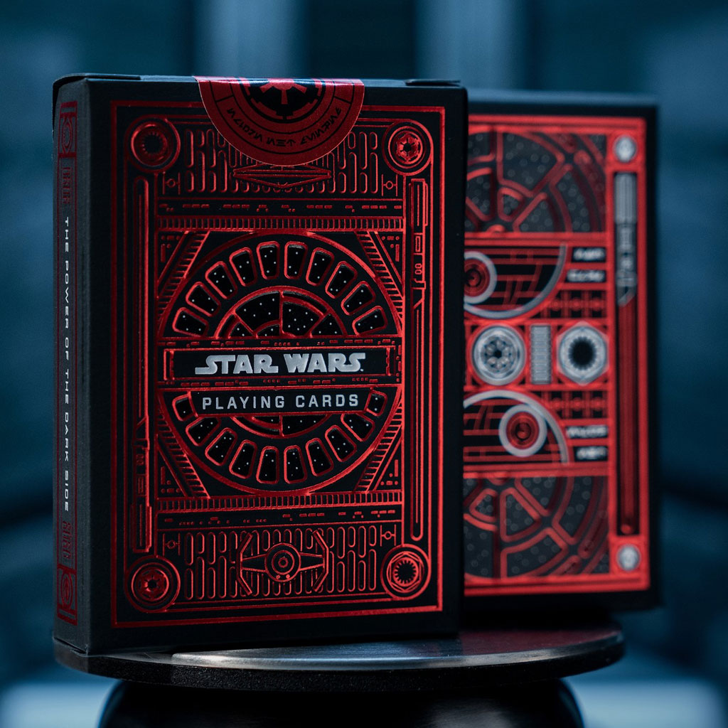 Two boxes of playing cards with metallic red foil design.