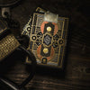 A close-up of a black and gold playing card deck.