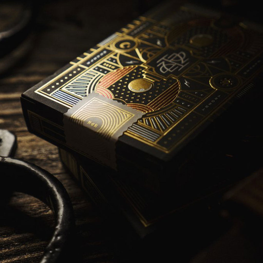 Closeup of an ornately-patterned deck of playing cards with metallic gold details.